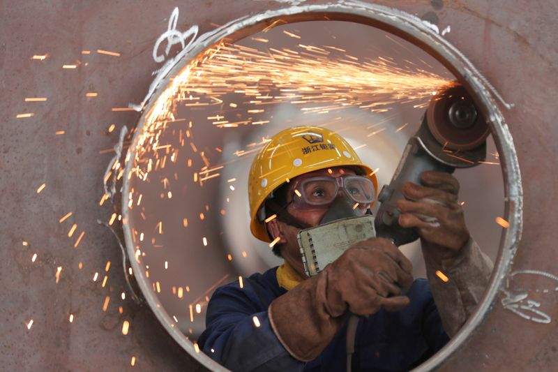 &copy; Reuters. FILE PHOTO: An employee works on a production line manufacturing steel structures at a factory in Huzhou, Zhejiang province, China May 17, 2020. China Daily via REUTERS//File Photo