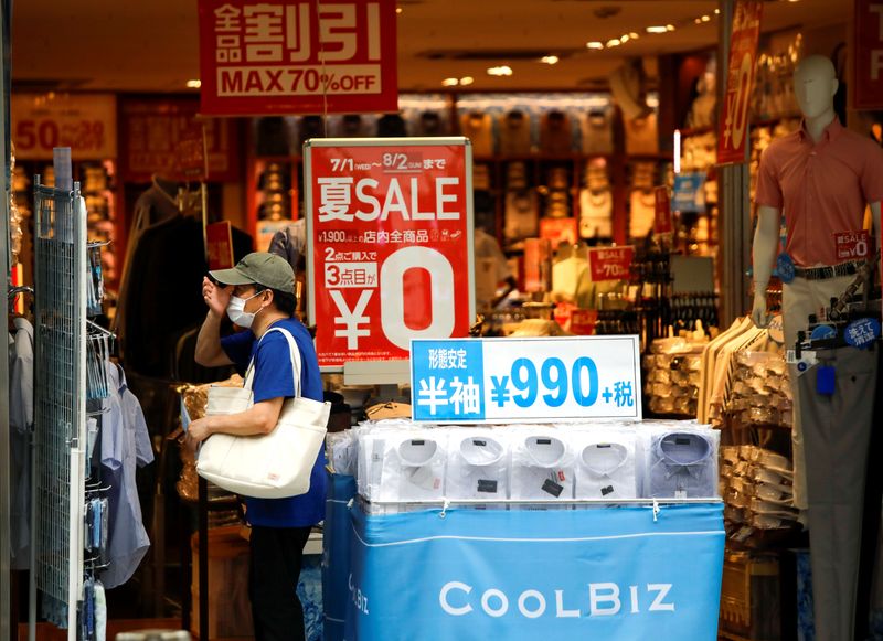 &copy; Reuters. A shopper wearing a protective face mask is seen at a shop selling office wear, amid the coronavirus disease (COVID-19) outbreak in Tokyo, Japan July 27, 2020.  REUTERS/Issei Kato/Files