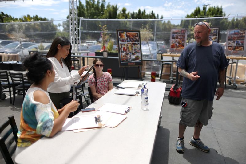 &copy; Reuters. FILE PHOTO: Line cook Ray Liberge, 48, attends a job fair for restaurant and hotel workers, after coronavirus disease (COVID-19) restrictions were lifted, in Torrance, near Los Angeles, California, U.S., June 23, 2021. REUTERS/Lucy Nicholson