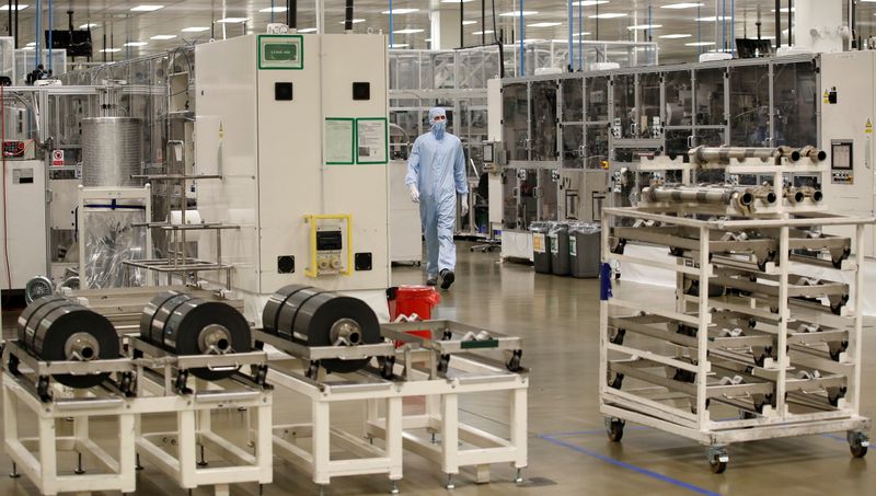 © Reuters. A worker in a protective suit walks inside the Envision battery manufacturing plant at Nissan's Sunderland factory, Britain, July 1, 2021. REUTERS/Phil Noble