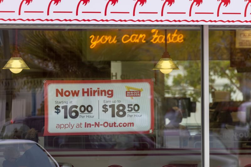 &copy; Reuters. An In-N-Out Burger advertises for workers at their restaurants location in Encinitas, California, U.S., May 10, 2021. REUTERS/Mike Blake