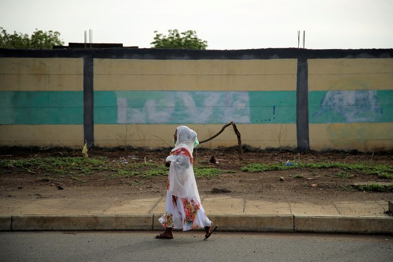 &copy; Reuters. FILE PHOTO: A woman walks along a street in Humera town, Ethiopia July 1, 2021. REUTERS/Stringer