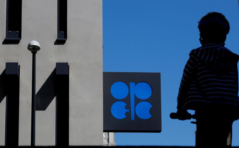&copy; Reuters. A person passes the logo of the Organization of the Petroleoum Exporting Countries (OPEC) in front of OPEC's headquarters in Vienna, Austria April 9, 2020.  REUTERS/Leonhard Foeger