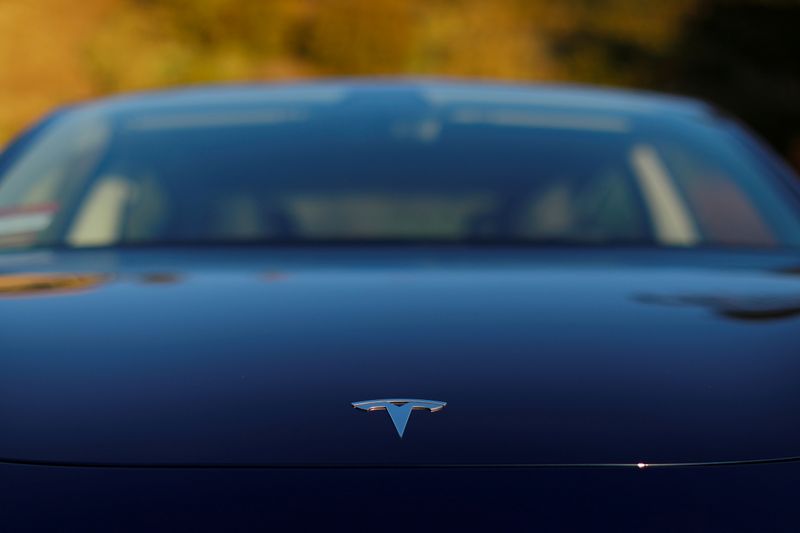 &copy; Reuters. FILE PHOTO: A 2018 Tesla Model 3 electric vehicle is shown in this photo illustration taken in Cardiff, California, U.S., June 1, 2018. REUTERS/Mike Blake