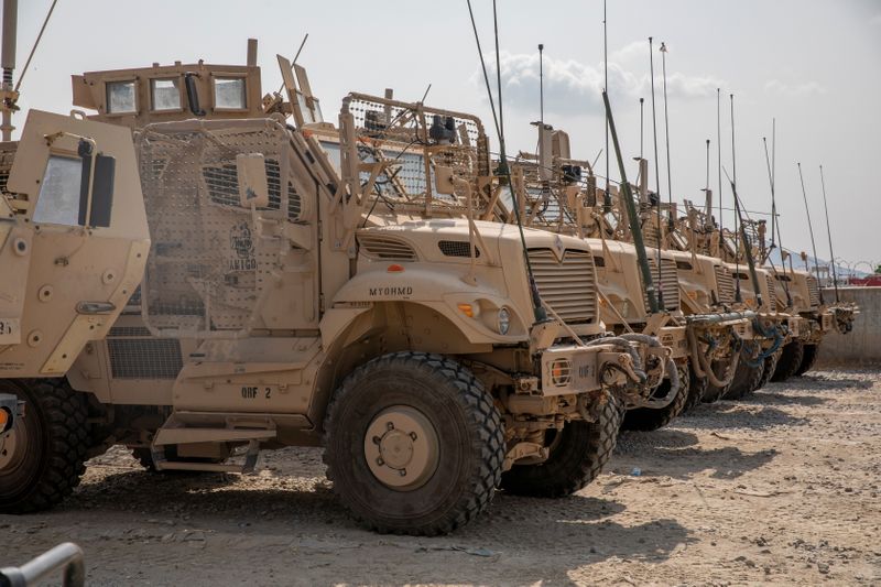 &copy; Reuters. U.S. Army soldiers from the 10th Mountain Division and U.S. contractors prepare Mine Resistant Ambush Protection vehicles, MRAPs, to be transported off of base in support of the withdrawl mission in Kandahar, Afghanistan, August 21, 2020.   U.S. Army/Sgt.