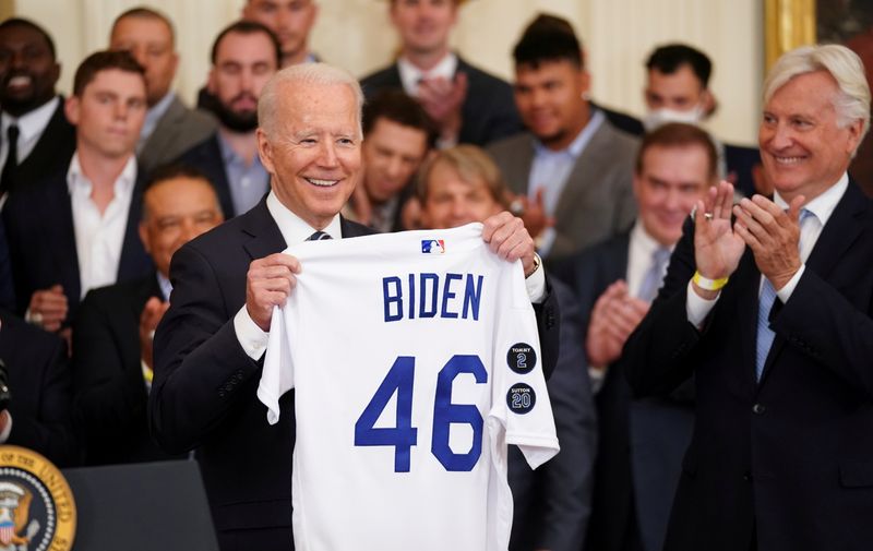 &copy; Reuters. FILE PHOTO: U.S. President Joe Biden holds up team a jersey given to him during a ceremony honoring the members of the 2020 World Series Champion Los Angeles Dodgers in the East Room at the White House in Washington, U.S., July 2, 2021. REUTERS/Kevin Lama