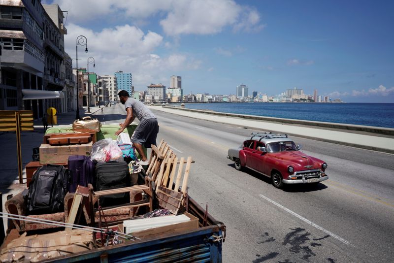 © Reuters. A man loads a truck with furniture to be relocated prior to the arrival of Storm Elsa, in Havana, Cuba, July 4, 2021. REUTERS/Alexandre Meneghini