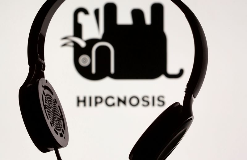 &copy; Reuters. FILE PHOTO: A headset is seen in front of a displayed Hipgnosis logo in this illustration taken June 28, 2021. REUTERS/Dado Ruvic/Illustration/File Photo  GLOBAL BUSINESS WEEK AHEAD
