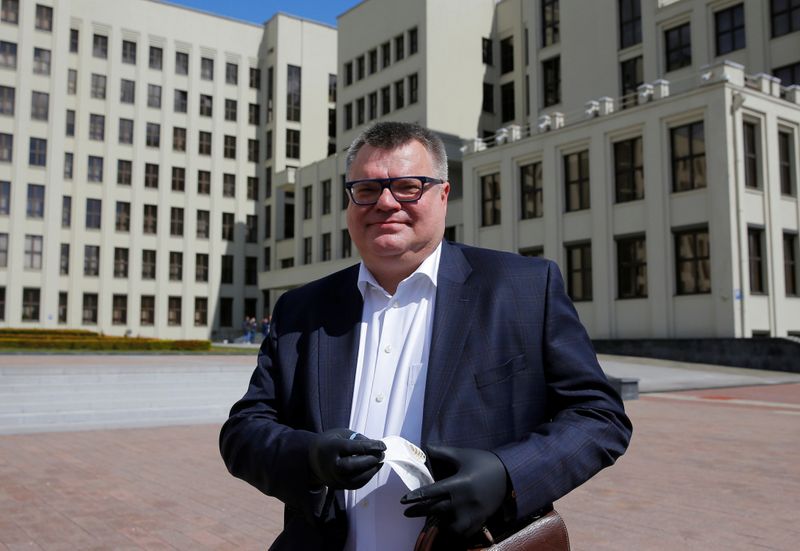 &copy; Reuters. Victor Babariko, former head of Belgazprombank, a subsidiary of Russian Gazprombank, wears protective gloves as he leaves the central election committee after registering the initiative group to nominate him as a candidate for the 2020 presidential electi