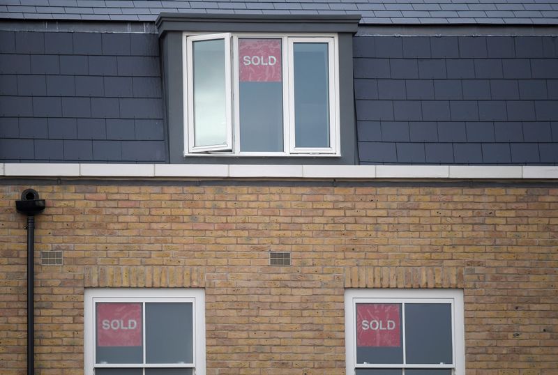 &copy; Reuters. Property sold signs are seen on windows of a group of newly built houses in west London, Britain, November 23, 2017. REUTERS/Toby Melville/Files
