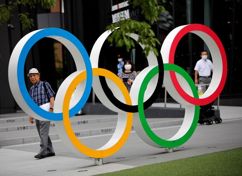 &copy; Reuters. Kohei Jinno, 87, who was forced to leave his house two times ahead of the 1964 and 2020 Olympics Games to make way for construction of the main stadium, walks next to the Olympic Rings monument outside the Japan Olympic Museum near the National Stadium, t