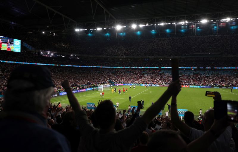 &copy; Reuters. FILE PHOTO: Soccer Football - Euro 2020 - Semi Final - England v Denmark - Wembley Stadium, London, Britain - July 7, 2021 England fans celebrate after the match Pool via REUTERS/Catherine Ivill  