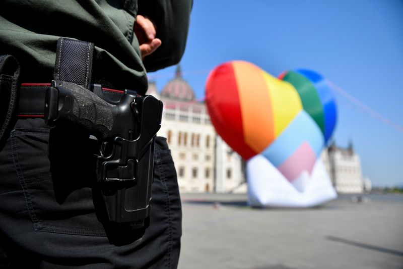 &copy; Reuters. A security officer stands guard near a huge rainbow baloon put up by members of Amnesty International and Hatter, an NGO promoting LGBT rights, at Hungary's parliament in protest against anti-LGBT law in Budapest, Hungary, July 8, 2021. REUTERS/Marton Mon