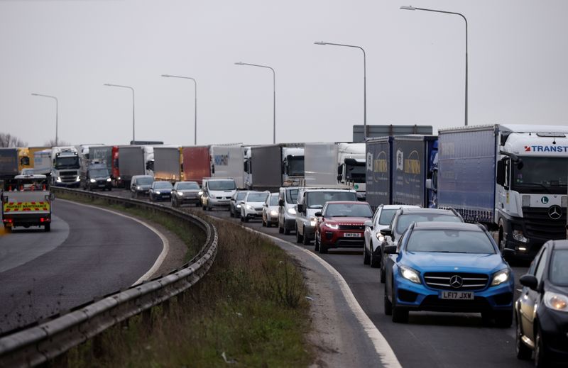 &copy; Reuters. Trucks queue on the road leading to the Waterbrook Inland Border Facility, a temporary customs clearance centre set up in a truck stop in Ashford, Kent, Britain January 15, 2021. REUTERS/John Sibley