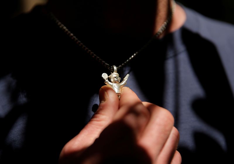 &copy; Reuters. Silver investor Kerry Kraker displays a silver figure nicknamed "Troy" by the "Wall Street Silver" Reddit community as he poses for a photograph at his home in Seattle, Washington, U.S., June 12, 2021. Picture taken June 12, 2021.  REUTERS/Lindsey Wasson