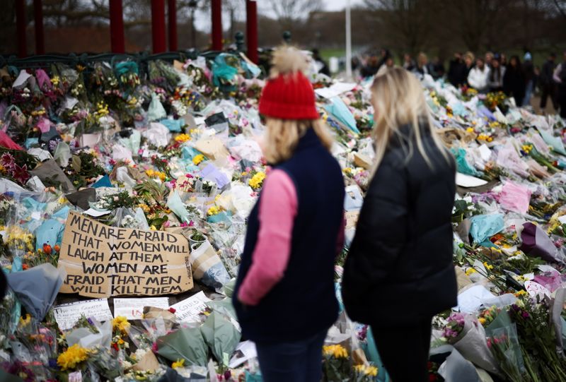&copy; Reuters. FILE PHOTO: People observe a memorial site at the Clapham Common Bandstand, following the kidnapping and murder of Sarah Everard, in London, Britain, March 21, 2021. REUTERS/Henry Nicholls