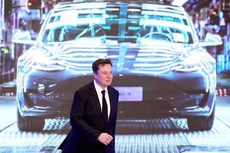 &copy; Reuters. FILE PHOTO: Tesla Inc CEO Elon Musk walks next to a screen showing an image of Tesla Model 3 car during an opening ceremony for Tesla China-made Model Y program in Shanghai, China January 7, 2020. REUTERS/Aly Song