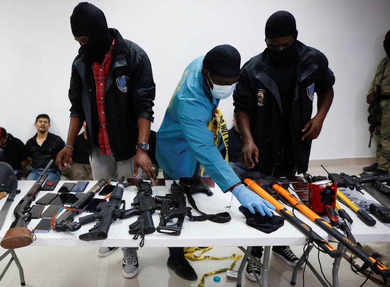 &copy; Reuters. Weaponry, mobile phones, passports and other items are being shown to the media along with suspects in the assassination of President Jovenel Moise, who was shot dead early Wednesday at his home, in Port-au-Prince, Haiti July 8, 2021. REUTERS/Estailove St