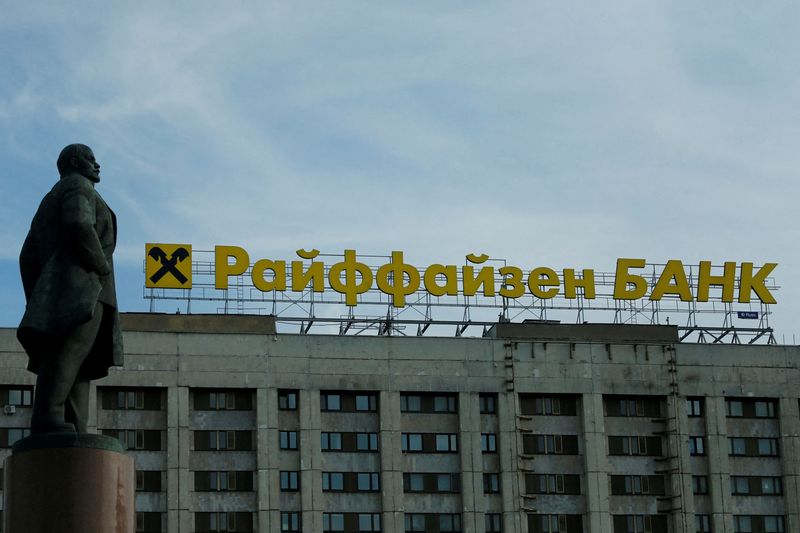 &copy; Reuters. FILE PHOTO: The logo of Raiffeisen Bank on top of a building is seen behind a statue of Soviet state founder Vladimir Leninin Moscow, Russia, June 14, 2016. REUTERS/Maxim Shemetov