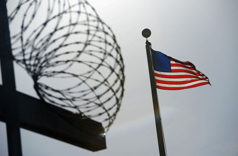 &copy; Reuters. FILE PHOTO: A U.S. flag flies above a razorwire-topped fence at the "Camp Six" detention facility at U.S. Naval Station Guantanamo Bay December 10, 2008. REUTERS/Mandel Ngan/Pool  (CUBA)/File Photo