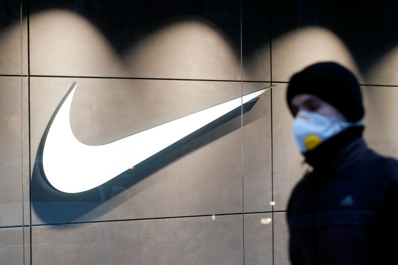 © Reuters. A man wearing a protective face mask amid the outbreak of the coronavirus disease (COVID-19) walks past a Nike brand store in central Kyiv, Ukraine December 10, 2020. REUTERS/Valentyn Ogirenko