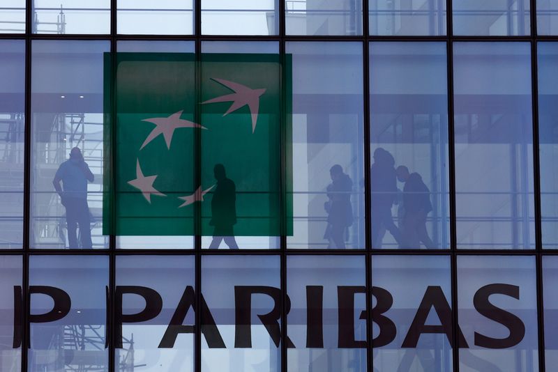 &copy; Reuters. FILE PHOTO: People are silhouetted as they walk behind the logo of BNP Paribas at the bank's building in Issy-les-Moulineaux, near Paris, France, February 3, 2022. REUTERS/Gonzalo Fuentes