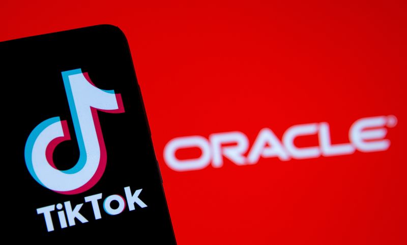 © Reuters. A smartphone with the Tik Tok logo is seen in front of a displayed Oracle logo in this illustration taken, Septemeber 14, 2020. REUTERS/Dado Ruvic/Illustration