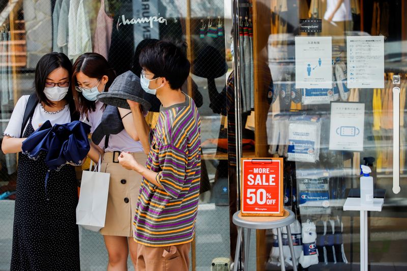 &copy; Reuters. People wearing masks stand outside a shop with infection prevention instructions on it's window in Harajuku shopping area, amid the coronavirus disease (COVID-19) outbreak in Tokyo, Japan August 9, 2021. REUTERS/Androniki Christodoulou