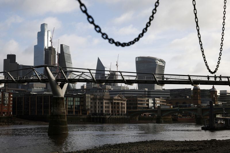 &copy; Reuters. FILE PHOTO: The City of London financial district is seen as people walk over Millennium Bridge in London, Britain, February 16, 2022. REUTERS/Henry Nicholls