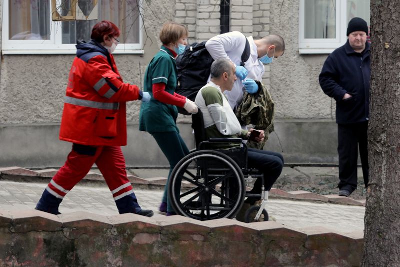 &copy; Reuters. Un militar herido es escoltado por trabajadores médicos, luego de un ataque a la base militar de Yavoriv, en medio de la invasión rusa de Ucrania, en un hospital en Novoiavorivsk, Ucrania, el 13 de marzo de 2022. REUTERS/Roman Baluk
