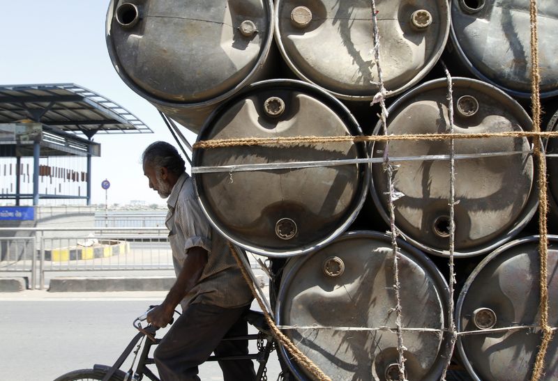 &copy; Reuters. A man rides his trishaw loaded with empty plastic barrels which are used to carry oil in the western Indian city of Ahmedabad March 10, 2011. REUTERS/Amit Dave/Files