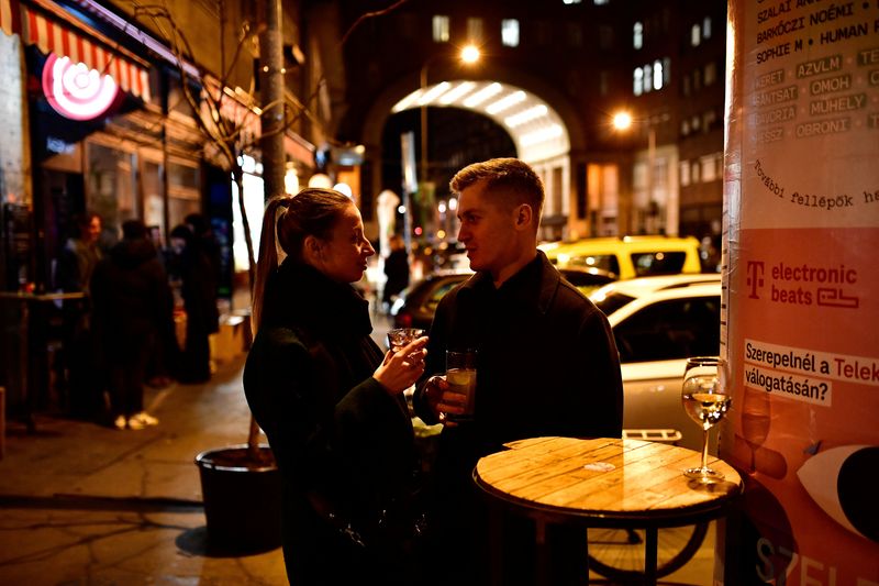 &copy; Reuters. Russian software engineer Mikhail Liublin, 31, and his Ukrainian lawyer girlfriend, Valeriia Nikolaieva, 25, who fled Ukraine drink in a bar, amid Russia's invasion of Ukraine, in Budapest, Hungary March 11, 2022. Picture taken March 11, 2022 REUTERS/Mart