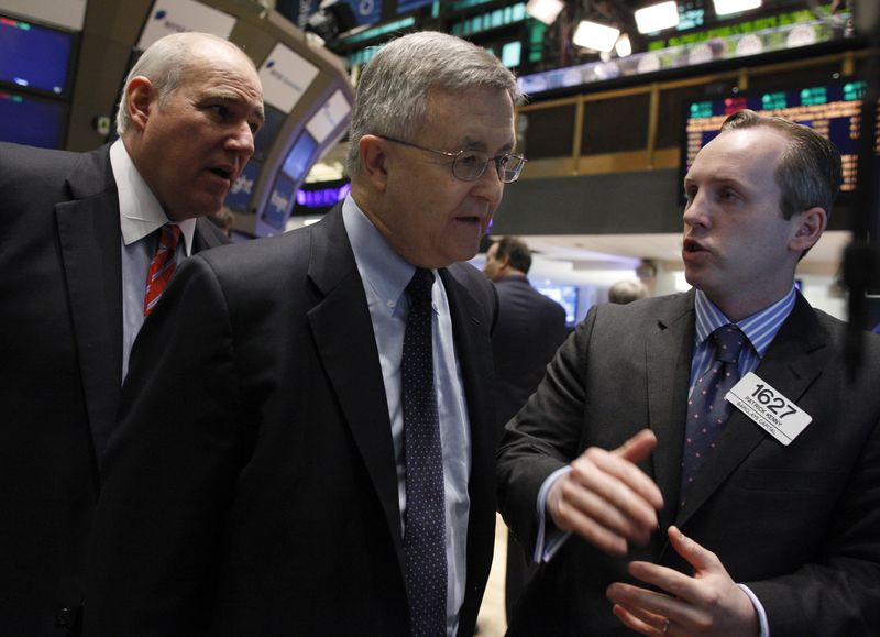 © Reuters. FILE PHOTO: LyondellBasell Industries CEO, Jim Gallogly (C) talks with Barclay's Capital trader Patrick Kenny on the floor of the New York Stock Exchange, May 2, 2011. REUTERS/Brendan McDermid  