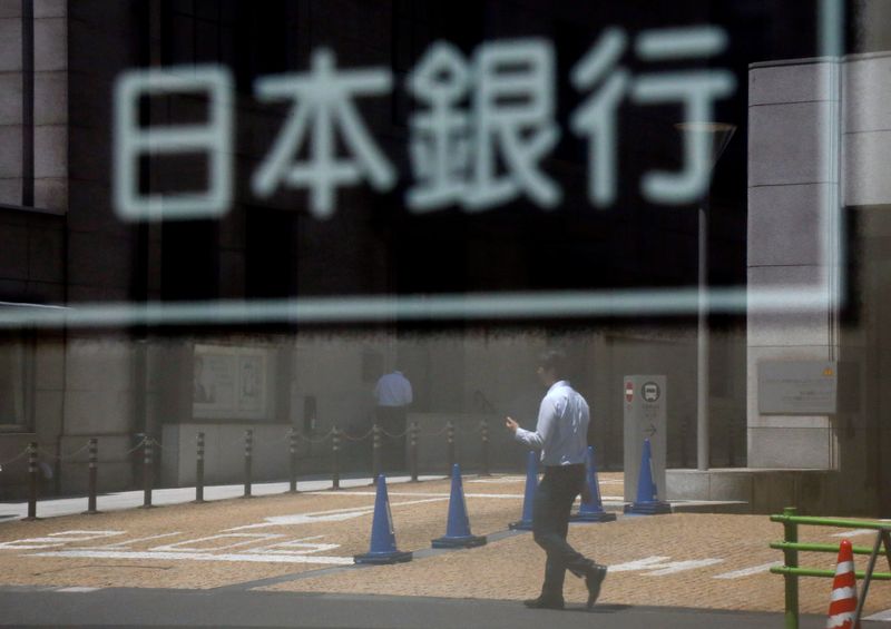 &copy; Reuters. FILE PHOTO: A man is reflected in a sign board of the Bank of Japan building in Tokyo, Japan June 16, 2017. REUTERS/Toru Hanai