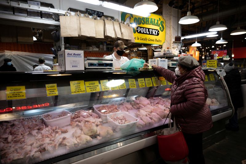 &copy; Reuters. FILE PHOTO: A customer shops at a poultry shop at Reading Terminal Market after the inflation rate hit a 40-year high in January, in Philadelphia, Pennsylvania, U.S., February 19, 2022. REUTERS/Hannah Beier