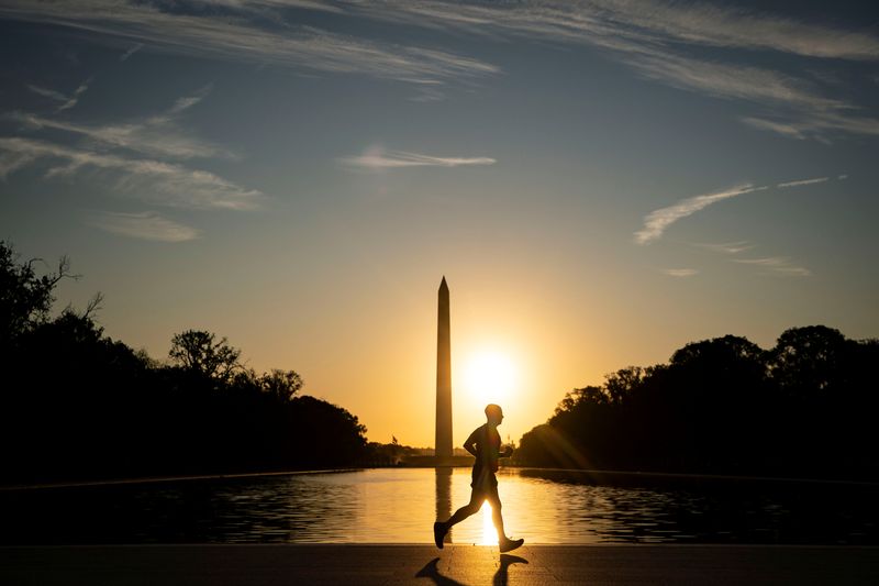 &copy; Reuters. FILE PHOTO: A man runs near the reflecting pool between the Lincoln Memorial and the Washington Monument at sunrise on the National Mall in Washington, U.S., September 19, 2019. REUTERS/Al Drago/File Photo