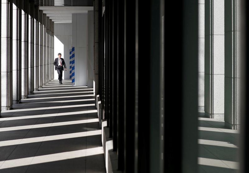 &copy; Reuters. A businessman walks at an office building in Tokyo, Japan January 23, 2019. REUTERS/Issei Kato