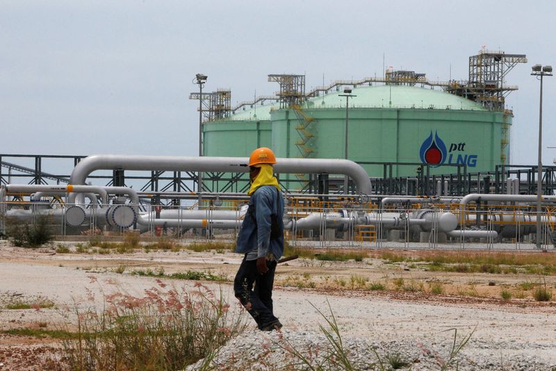 &copy; Reuters. FILE PHOTO: An employee of Thai energy giant PTT walks outside the company's Liquefied Natural Gas (LNG) terminal at the Map Ta Phut industrial estate in Rayong province, east of Bangkok September 7, 2011. REUTERS/Sukree Sukplang