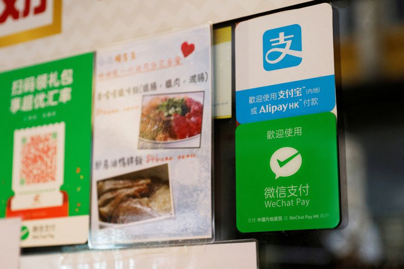 &copy; Reuters. FILE PHOTO: Logos for digital payment services Alipay by Ant Group, an affiliate of Alibaba Group Holding and WeChat Pay by Tencent Holdings are displayed outside a restaurant, in Hong Kong, China November 1, 2020. REUTERS/Tyrone Siu