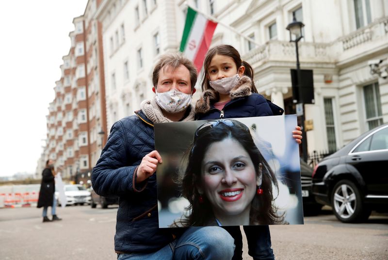 &copy; Reuters. FILE PHOTO: Richard Ratcliffe, husband of British-Iranian aid worker Nazanin Zaghari-Ratcliffe, and their daughter Gabriella protest outside the Iranian Embassy in London, Britain March 8, 2021. REUTERS/Andrew Boyers