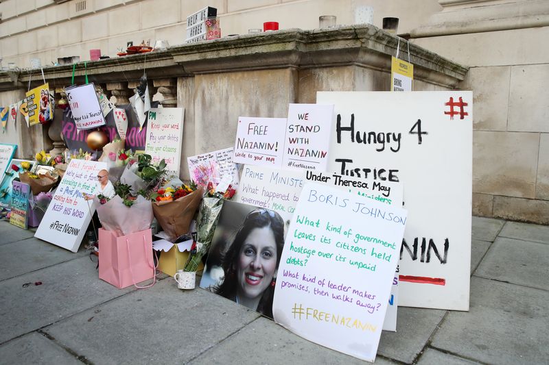 &copy; Reuters. FILE PHOTO: Flowers, pictures and messages of support are seen as Richard Ratcliffe (not pictured), husband of British-Iranian aid worker Nazanin Zaghari-Ratcliffe, speaks during an interview on day 19 of a hunger strike outside the Foreign, Commonwealth 