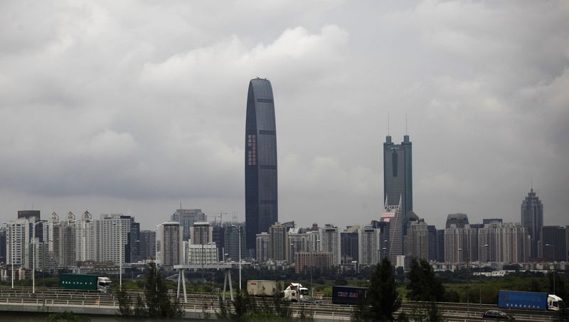 &copy; Reuters. FILE PHOTO: Container trucks cross a bridge in front of the 100-floor Kingkey 100, the tallest building in downtown Shenzhen neighboring Hong Kong, May 16, 2012.  REUTERS/Bobby Yip 