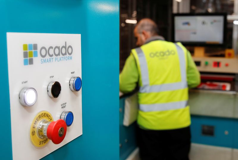 &copy; Reuters. FILE PHOTO: A worker packs bags inside an Ocado warehouse in Erith, London, Britain, October 13, 2021. To match Special Report RETAIL-ROBOTS/OCADO. REUTERS/Paul Childs