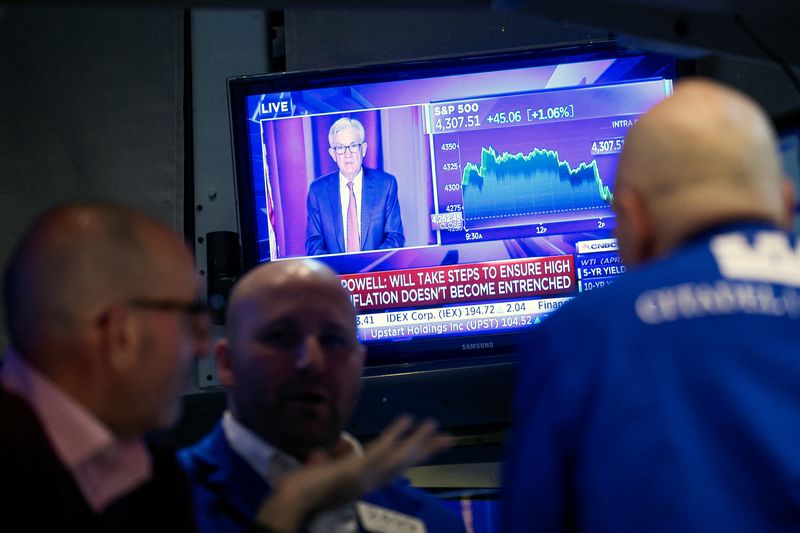 &copy; Reuters. FILE PHOTO: Traders work, as Federal Reserve Chair Jerome Powell is seen on a screen delivering remarks, at the New York Stock Exchange (NYSE) in New York City, U.S., March 16, 2022.  REUTERS/Brendan McDermid