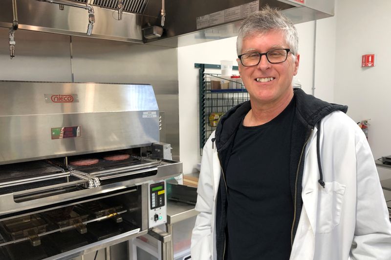 &copy; Reuters. FILE PHOTO: Impossible Foods Chief Executive Pat Brown poses in front of a flame broiler cooking its plant-based patties at a facility in Redwood City, California, U.S. March 26, 2019. REUTERS/Jane Lanhee Lee