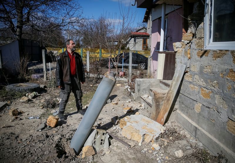 © Reuters. رجل يفحص بقايا قذيفة صاروخية سقطت على منزله شمال اقليم كييف يوم الخميس. تصوير: جليب جارانيتش - رويترز. 