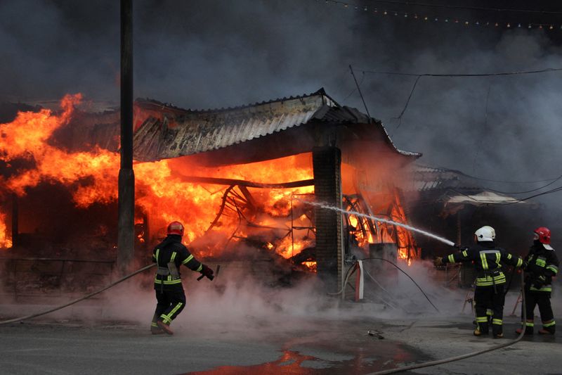 &copy; Reuters. Firefighters work at the site of a fire at the Barabashova market, as Russia's invasion of Ukraine continues, in Kharkiv, Ukraine March 17, 2022. REUTERS/Oleksandr Lapshyn