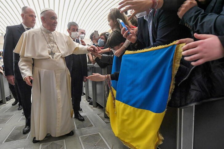 &copy; Reuters. El Papa Francisco saluda a personas con una bandera de Ucrania en su audiencia general semanal en el Salón de Pablo VI en el Vaticano. 16 marzo 2022. Medios vaticanos/entrega vía Reuters. ATENCIÓN EDITORES - ESTA IMAGEN FUE ENTREGADA POR UNA TERCERA PA