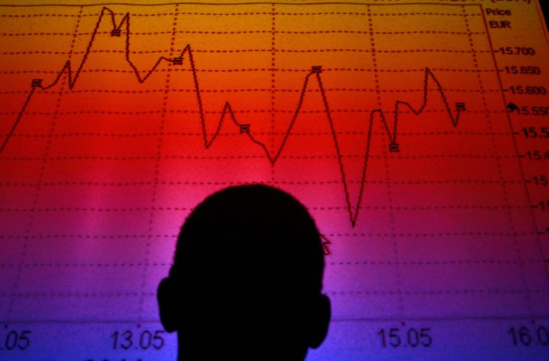 &copy; Reuters. FILE PHOTO: A man is silhouetted in an electronic board showing the FTSE MIB Index for the Italian equity market in this photo illustration taken in Rome August  9, 2011.  REUTERS/Tony Gentile