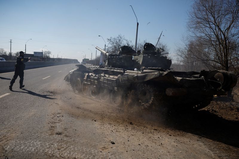 &copy; Reuters. جندي أوكراني يوجه دبابة روسية سيطر عليها الأوكرانيون بعد قتال مع القوات الروسية خارج بلدة بروفاري قرب العاصمة الأوكرانية كييف يوم 10 مارس آذ